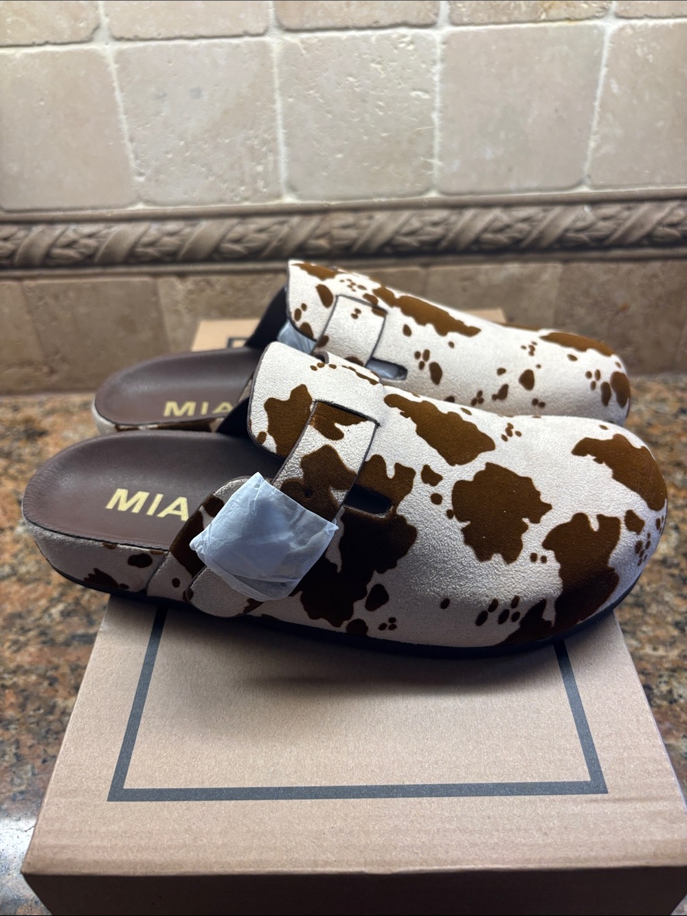 MIA Cow Print Slip-On Clogs in White and Brown